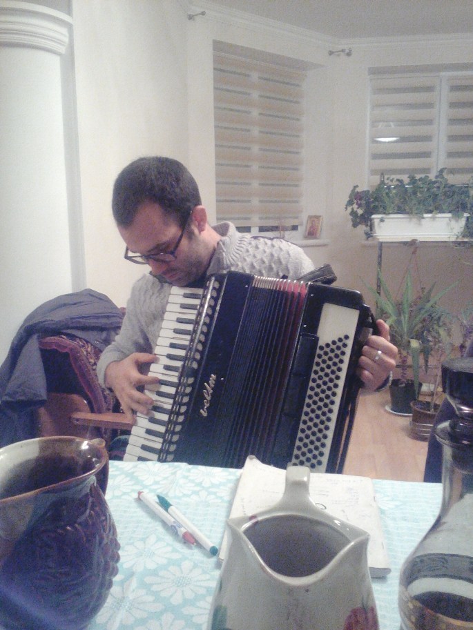 Aaron, one of the other volunteers, attempting to play the accordion