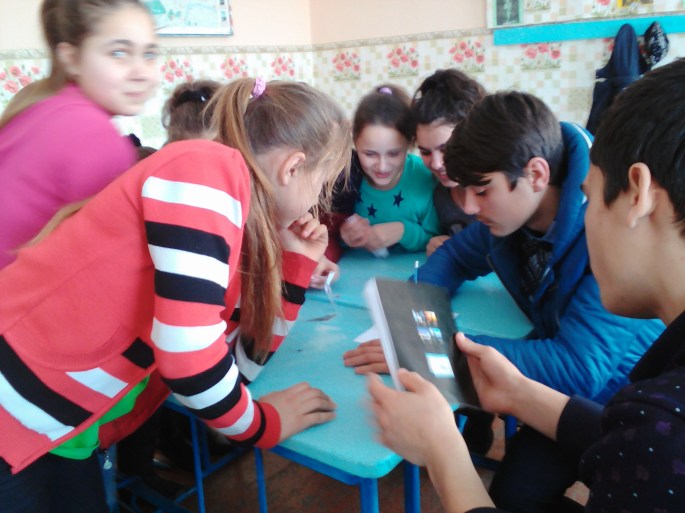 Students work on a grammar exercise during a team competition